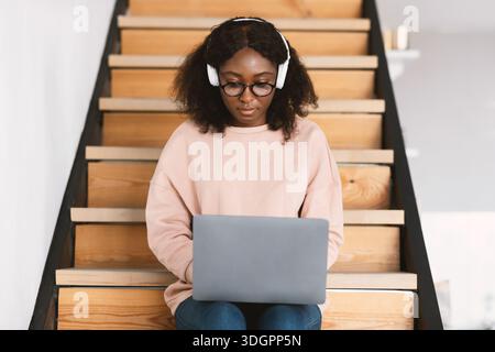 Black Young Female Freelancer Using Laptop Working Online At Home Stock Photo