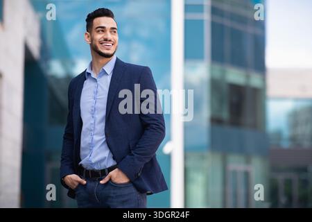 Young arab man standing by business center Stock Photo