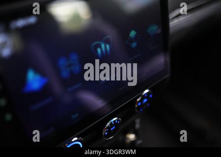The process of choosing climate control in the car. Man regulating temperature on car air condition. Modern car interior Stock Photo