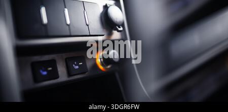 The process of choosing climate control in the car. Man regulating temperature on car air condition. Modern car interior Stock Photo
