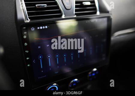 The process of choosing climate control in the car. Man regulating temperature on car air condition. Modern car interior Stock Photo