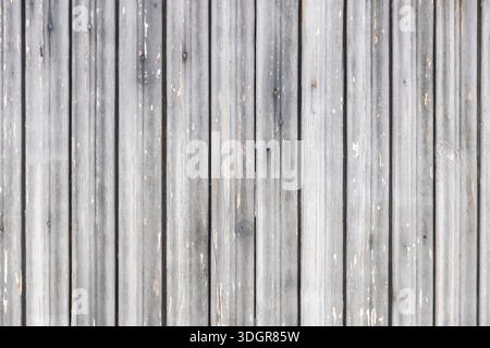 A horizontal texture of old, weathered wooden boards with faded grey paint, showing signs of decay and natural wood grain. Stock Photo