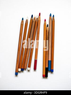 Multicolored pencils isolated on white background, top view. Wooden colorful pencils on a white table. Back to school. Art supplies for drawing and gr Stock Photo