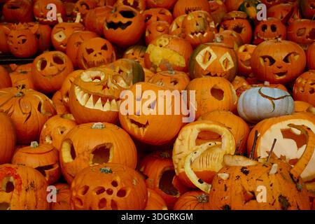 A large collection of carved pumpkins and jack-o’-lanterns displayed together ahead of Halloween in Dalston, London, England Stock Photo