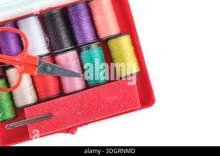 Sewing accessories in red box on white background Stock Photo