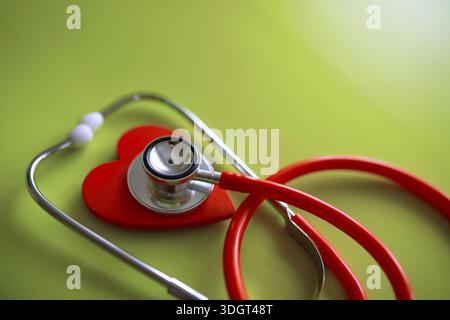 Doctor at his desk in the clinic's office. Stethoscope, test tubes, laptop, prescriptions, glasses on table. Stock Photo