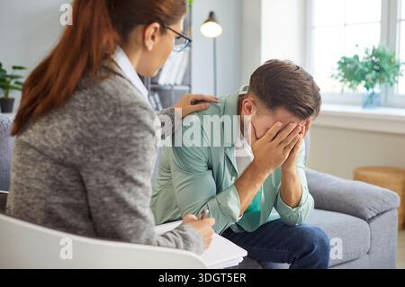 Psychologists appointment, consultation of depressed man with therapist in office Stock Photo