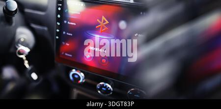 The process of choosing climate control in the car. Man regulating temperature on car air condition. Modern car interior Stock Photo