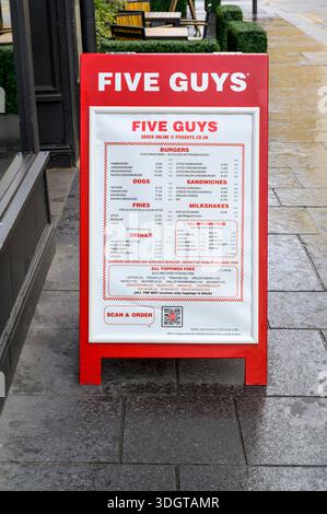 A Five Guys menu board on a pavement, UK Stock Photo