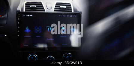 The process of choosing climate control in the car. Man regulating temperature on car air condition. Modern car interior Stock Photo