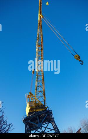 A tall yellow crane in The Shipyards by Lonsdale Quay in North Vancouver, BC. Stock Photo