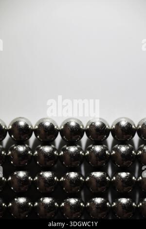 Metal balls close up. Balls of neodymium (magnets). magnetic ball bearing tiling in perfect hexagonal grid Stock Photo