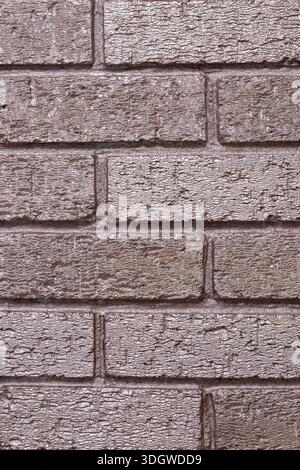 Brick wall background backdrop painted with metallic rose gold coloured paint. Interior design concept. Stock Photo