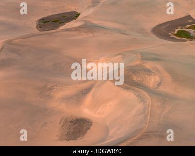 Aerial Maspalomas Dunes, Gran Canaria, wind shaped ridges at dusk Stock Photo