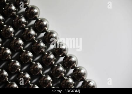 Metal balls close up. Balls of neodymium (magnets). magnetic ball bearing tiling in perfect hexagonal grid Stock Photo