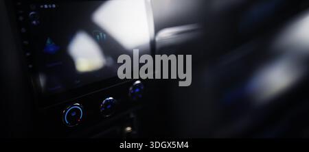 The process of choosing climate control in the car. Man regulating temperature on car air condition. Modern car interior Stock Photo