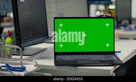 Isolated screen laptop on office desk used to implement algorithms enabling machine learning. Artificial intelligence technology company workspace with mockup notebook used to conduct code reviews Stock Photo