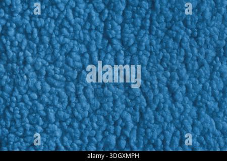 Vibrant blue color fabric texture of soft faux fur cloth with fluffy surface, abstract background. Close up, macro of shaggy fabric texture, upholster Stock Photo