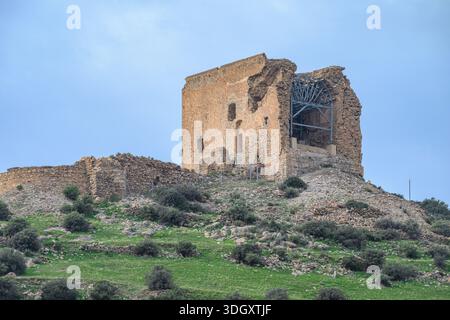 Exterior daytime shot of the Castle  of Castell de Ferro ruins displaying visible stone masonry and modern metal reinforcement on a hilltop in Andalus Stock Photo