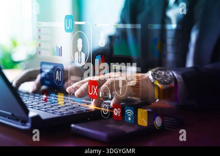 Businessman typing on laptop with virtual UI/UX, AI and dashboard icons, representing user interface design, product development, usability testing, a Stock Photo