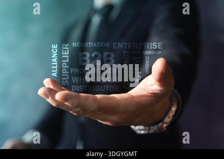 Open hand presenting B2B word cloud with supplier, procurement, contract, and enterprise terms, symbolizing corporate partnerships, wholesale distribu Stock Photo