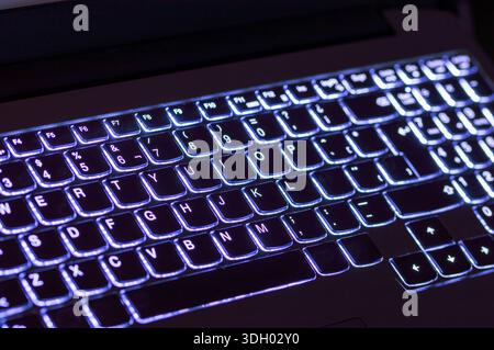 Closeup of laptop blue keyboard illumination, backlit keyboard Stock Photo