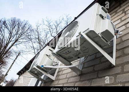 Outdoor two split air conditioning units mounted on siding wall. Stock Photo