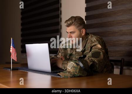 Serious man working on a laptop at a desk and thinking about a business project Stock Photo