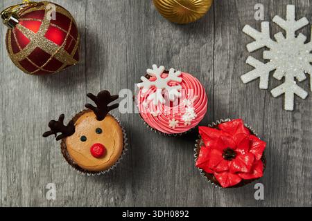 Red Christmas cupcake with snowflake topper and golden ornament Stock Photo