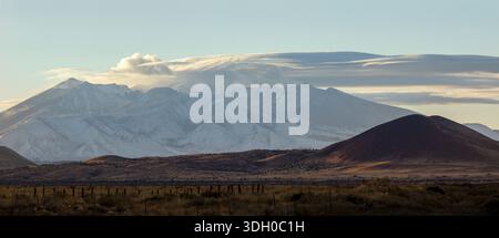 Dramatic clouds over snowy mountain landscape Stock Photo