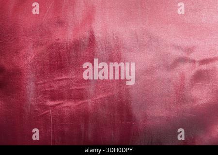 Abstract textured red background with rough brushed metal surface showing scratch marks and grunge details for creative artistic design wallpaper with Stock Photo