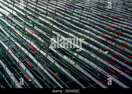 Architectural detail. Geometric abstract background of windows and coloured lights. Stock Photo