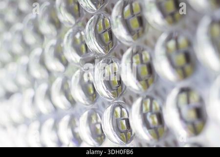 Macro view of bright white led panel showing futuristic technology grid with diode pattern creating cool energy sensation and abstract industrial text Stock Photo