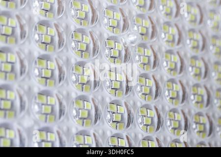 Close up view of bright yellow LED diode matrix panel with futuristic technological pattern creates illuminated abstract background symbolizing effici Stock Photo