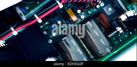 Electronic circuit board with capacitors, wiring, and power components inside modern equipment. Electrical engineering design, industrial hardware Stock Photo