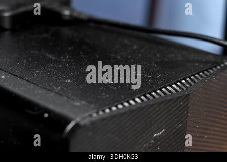 Dusty office computer with external memory drive on top close up Stock Photo