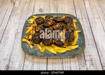 Burgos black pudding, fried in a pan, with crispy casings and a rice and blood filling slightly crumbling at the edges, freshly made Stock Photo