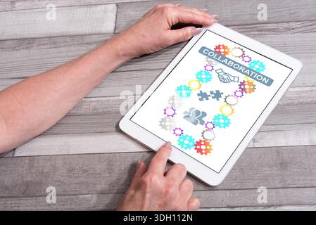 Collaboration concept shown on a tablet used by a woman Stock Photo