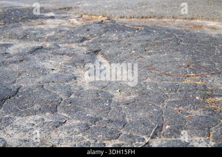 Cracked asphalt texture. Road background top view. Cracks in specialized road surface. Structured, background image Stock Photo
