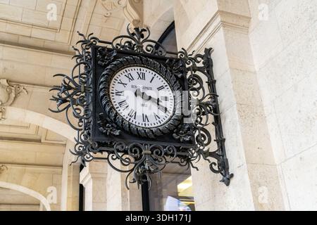 Paris, France - October 29, 2025: Old clock Henry Lepaute 1885 on wall LA POSTE Paris Louvre post office. Black metal design Stock Photo