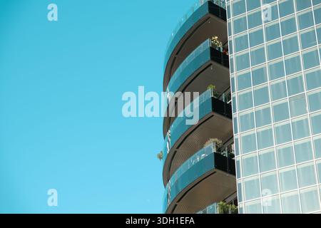 abstract architecture background with modern glass building against blue sky, background with copy space Stock Photo