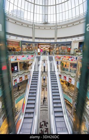 Symmetrical escalators in a spacious and bright shopping center, London, England, Great Britain Stock Photo
