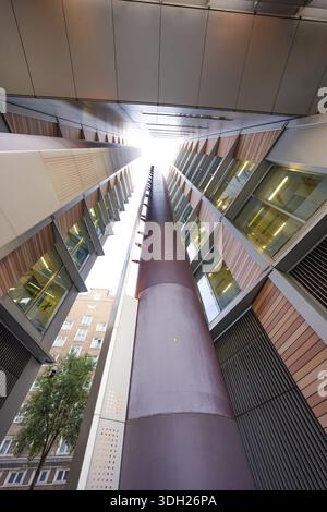 A symmetrical upward look between two modern buildings, London, England, Great Britain Stock Photo