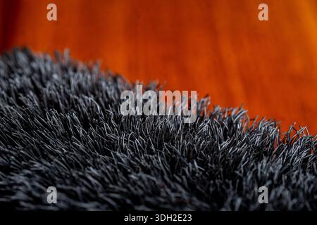 Extreme close up of dense black synthetic bristles, showing abstract fiber texture and detailed industrial material pattern. Stock Photo