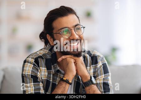 Handsome millennial arab man resting at home Stock Photo