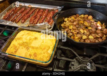 Denver, Colorado - Eggs, potatoes, and bacon on the stove for breakfast. Stock Photo