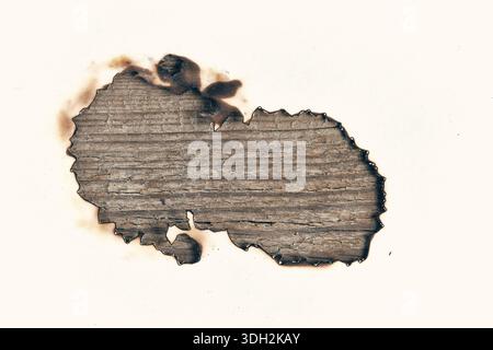 Burnt out white sheet of paper with wooden texture on background Stock Photo