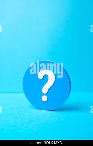 A question mark in a blue circle. FAQ and surveys. Ask a question. Get information. User support concept, inquiry culture, feedback channels and knowl Stock Photo