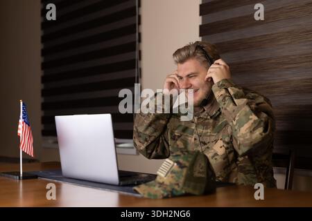 Professional man working on a laptop with concentration in an office room Stock Photo