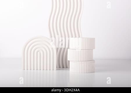 White concrete advertising stands. Gypsum podium for the presentation of cosmetic products. Minimal mock up. Stock Photo